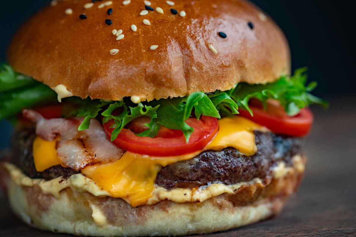 Illustrative food photograph: two-pan classic beef burgers at home