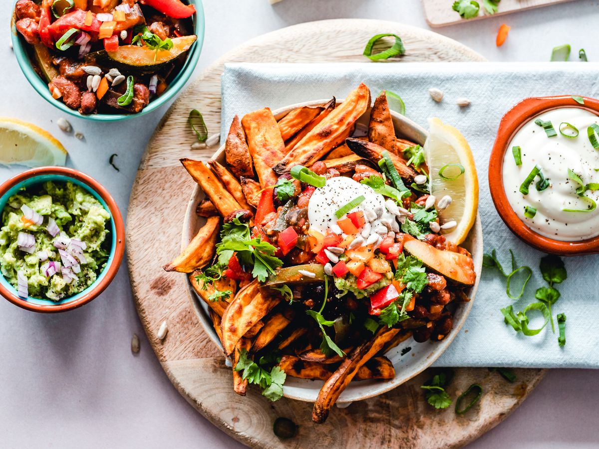 Illustrative food photograph: loaded sweet-potato wedges with quick bean salsa