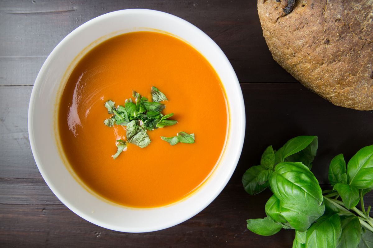 Illustrative food photograph: carrot and ginger soup in one small pot